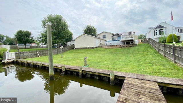 dock area with a deck with water view and a yard