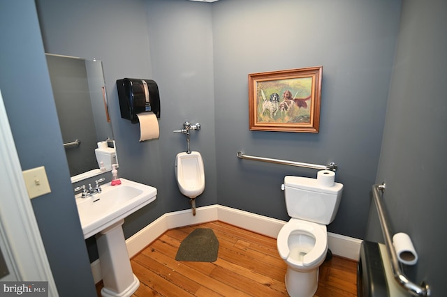 bathroom with toilet, hardwood / wood-style floors, and sink