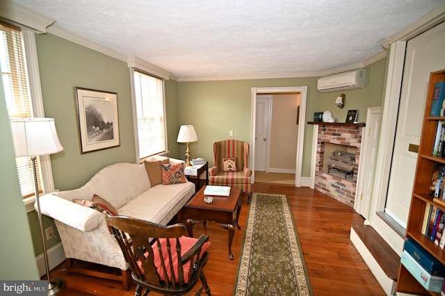 living room with a brick fireplace, a textured ceiling, a wall mounted AC, crown molding, and dark hardwood / wood-style flooring