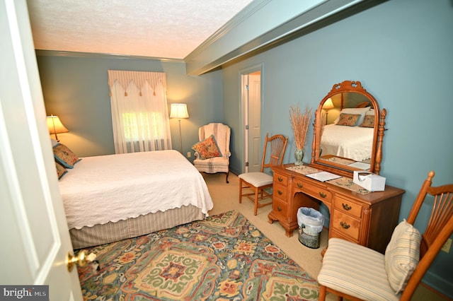 bedroom featuring a textured ceiling, light carpet, and crown molding