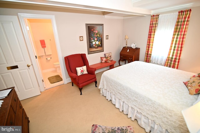 bedroom featuring light carpet, connected bathroom, and beamed ceiling