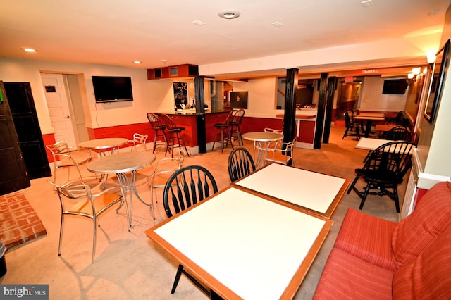 dining area featuring light carpet and an inviting chandelier