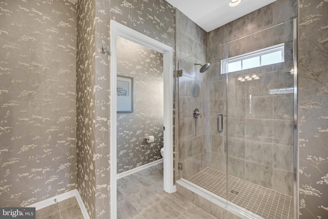 bathroom featuring walk in shower, tile floors, and toilet