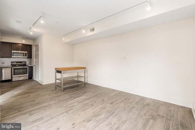 interior space featuring track lighting and light wood-type flooring