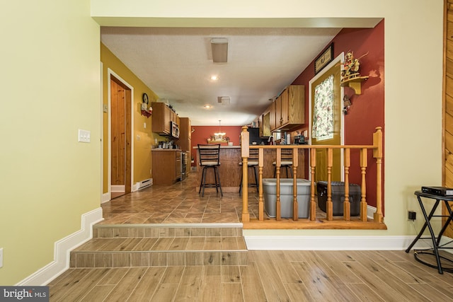 kitchen featuring light tile flooring and pendant lighting