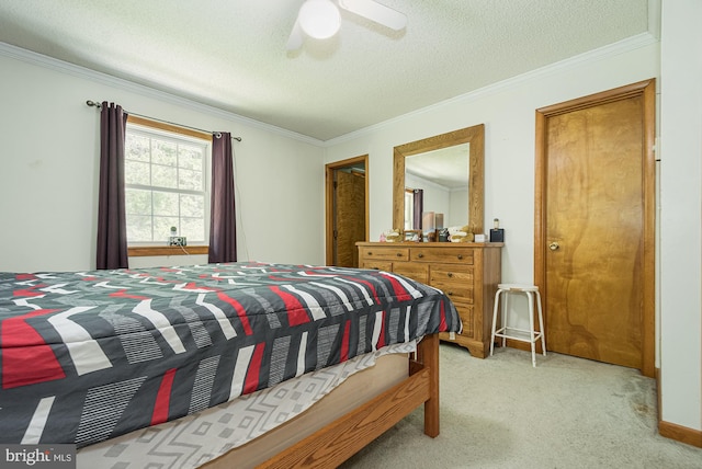 bedroom with ceiling fan, crown molding, light colored carpet, and a textured ceiling