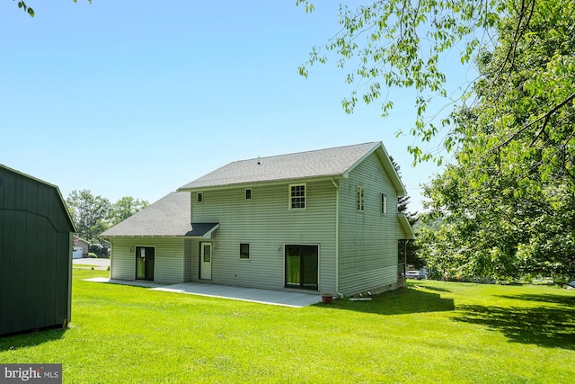 rear view of property with a lawn and a patio area