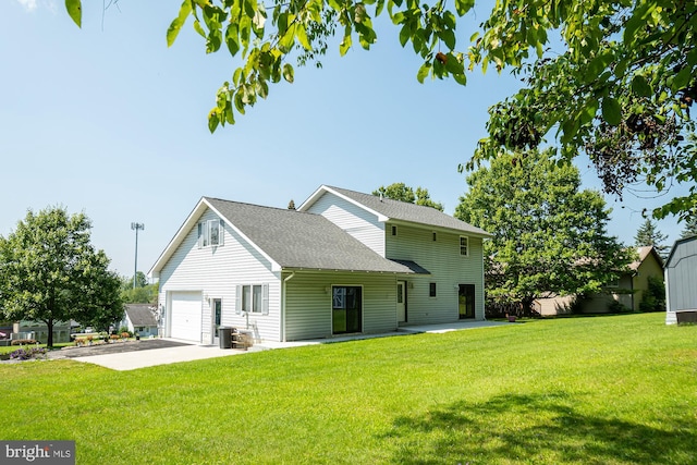 view of front of home with a front yard, central air condition unit, and a garage