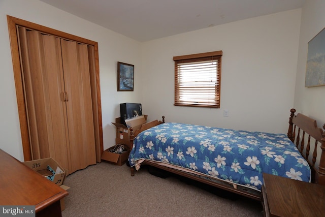 bedroom with carpet and a closet