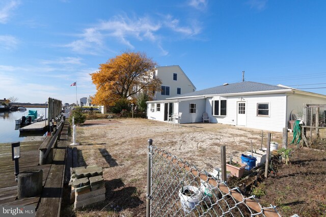 back of property featuring a water view