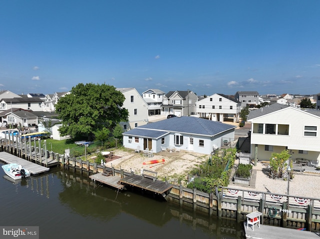 rear view of property with a water view