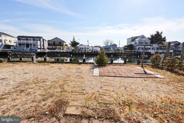 view of yard featuring a water view and a dock