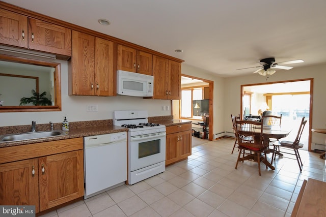 kitchen with ceiling fan, white appliances, sink, and a wealth of natural light