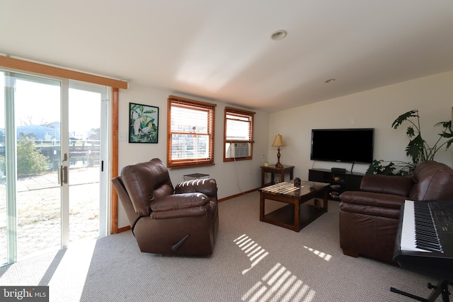 carpeted living room featuring vaulted ceiling and french doors