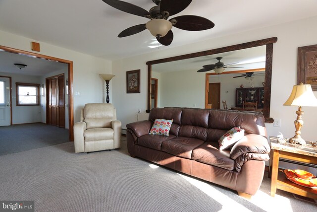 carpeted living room featuring ceiling fan