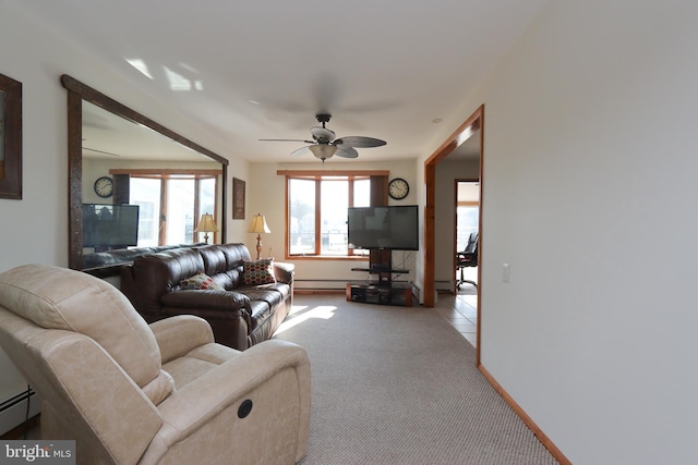 carpeted living room featuring a baseboard heating unit and ceiling fan