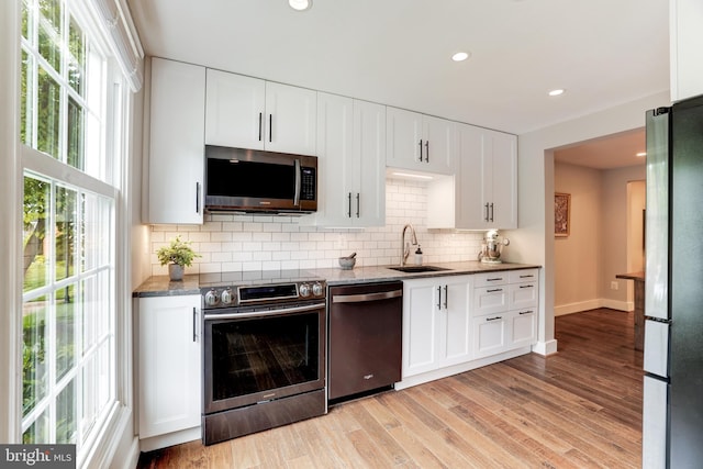 10905 Harpers Square Ct, Reston, VA 20191 - kitchen featuring recessed lighting, a sink, stainless steel appliances, backsplash, and white cabinetry