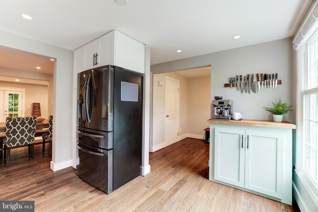 10905 Harpers Square Ct, Reston, VA 20191 - kitchen with stainless steel fridge, butcher block countertops, a healthy amount of sunlight, and light wood-style floors