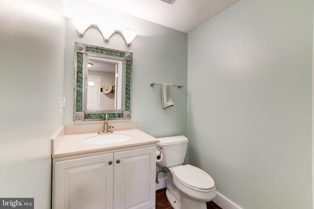 10905 Harpers Square Ct, Reston, VA 20191 - bathroom featuring baseboards, wood finished floors, toilet, and vanity