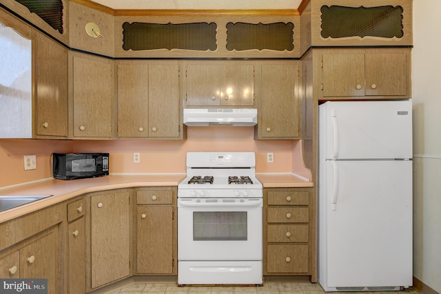 kitchen featuring light tile flooring and white appliances