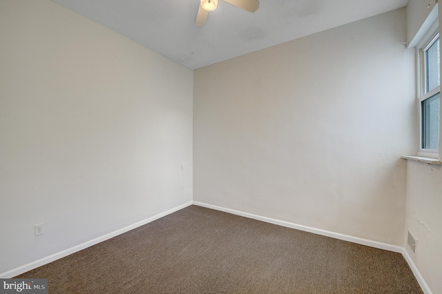 carpeted spare room with ceiling fan