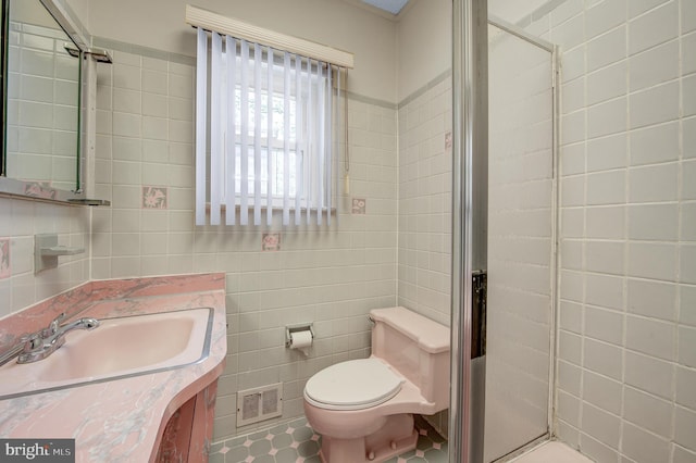 bathroom with tile walls, walk in shower, toilet, tile floors, and oversized vanity