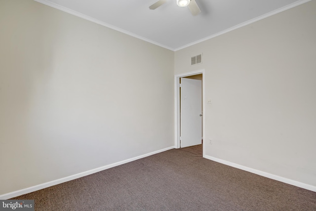 empty room with ornamental molding, ceiling fan, and dark colored carpet