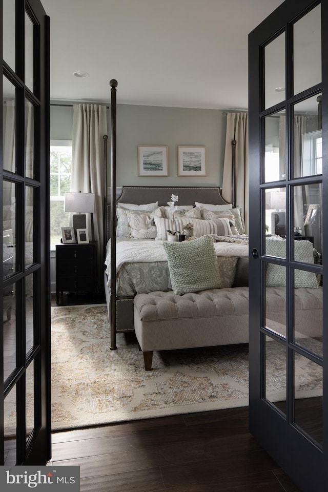 bedroom with french doors and hardwood / wood-style flooring