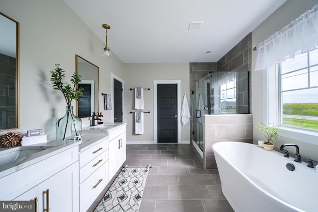 bathroom with separate shower and tub, tile patterned flooring, and vanity