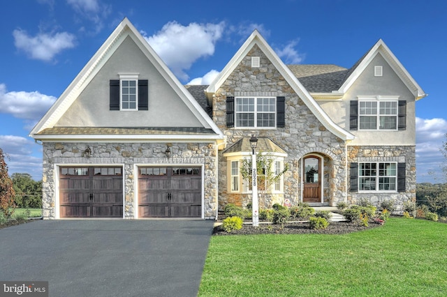 view of front of house with a garage and a front lawn