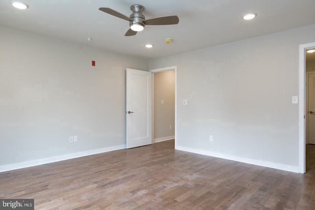 spare room featuring ceiling fan and dark wood-type flooring