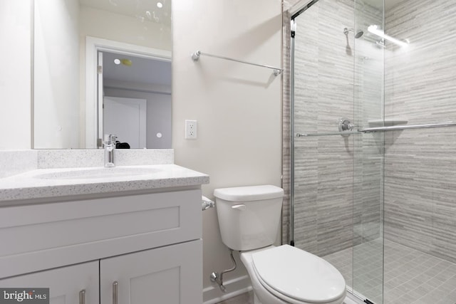 bathroom with toilet, large vanity, and walk in shower