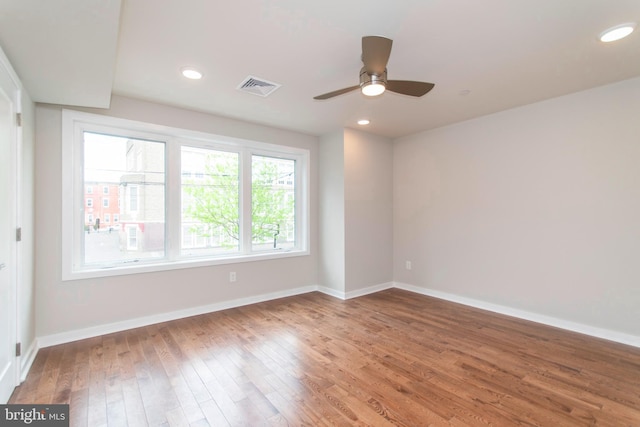 unfurnished room featuring ceiling fan and dark wood-type flooring