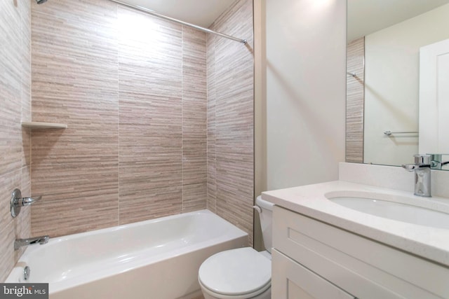 full bathroom with oversized vanity, toilet, and tiled shower / bath