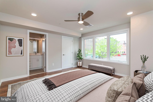 bedroom featuring ceiling fan, wood-type flooring, and ensuite bathroom