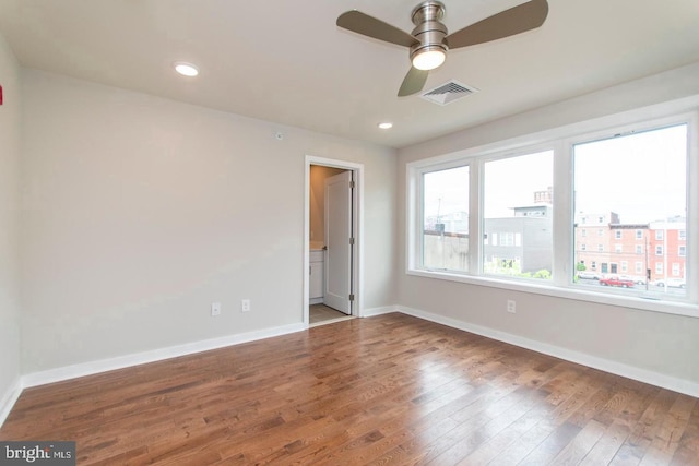 unfurnished room with ceiling fan and dark hardwood / wood-style floors