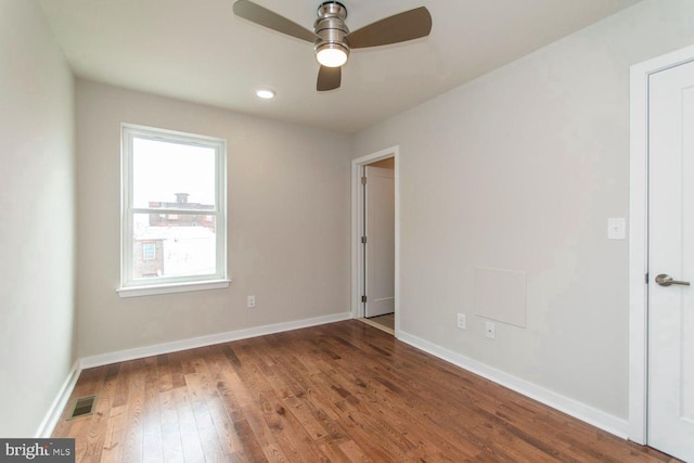 spare room featuring ceiling fan and dark hardwood / wood-style flooring