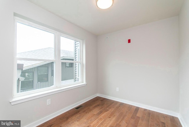 spare room with light hardwood / wood-style flooring and plenty of natural light