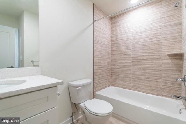 full bathroom featuring tiled shower / bath, toilet, and vanity