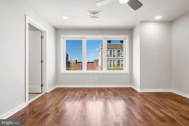 unfurnished room with ceiling fan and light wood-type flooring