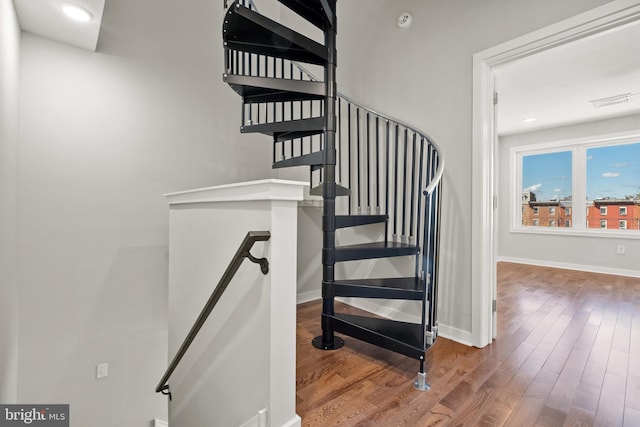 staircase featuring dark hardwood / wood-style floors