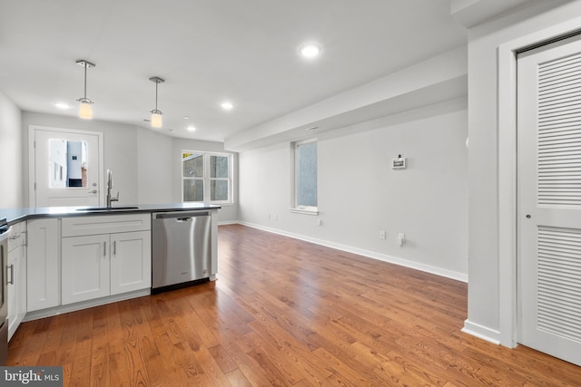 kitchen featuring sink, white cabinetry, light hardwood / wood-style floors, and dishwasher