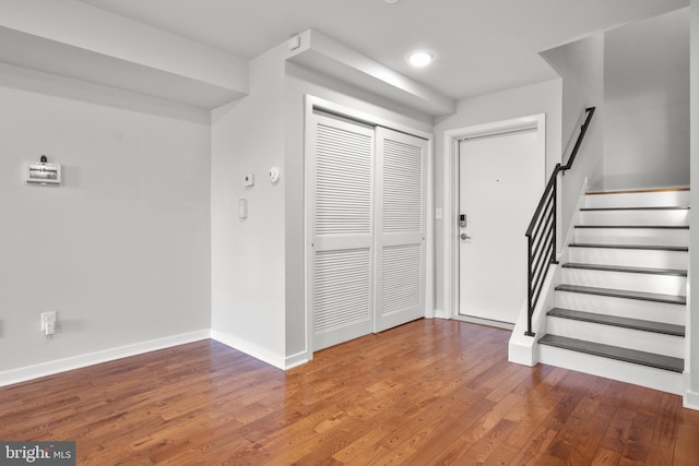 entryway with dark hardwood / wood-style flooring