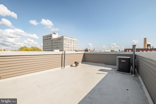 view of terrace with a balcony and central air condition unit