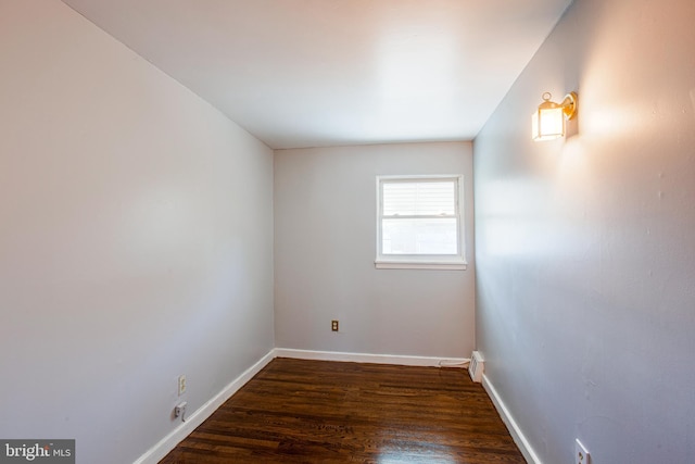 spare room with dark hardwood / wood-style flooring