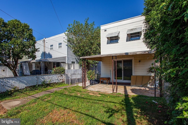 back of property with a patio area and a yard