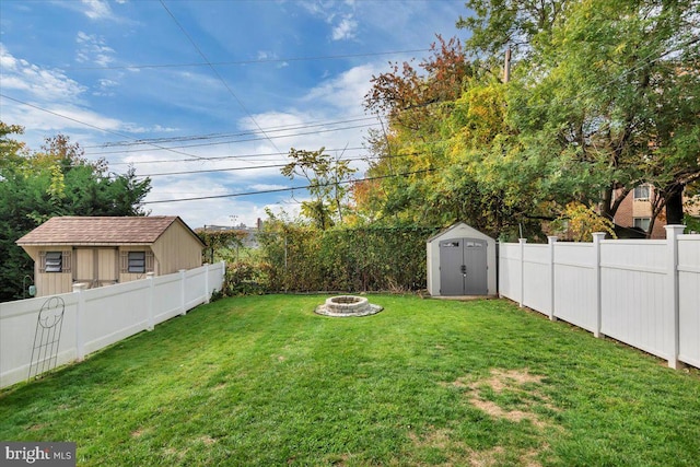 view of yard with an outdoor fire pit and a storage unit