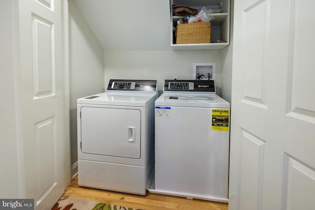 clothes washing area with washer hookup, light wood-type flooring, and washer and dryer