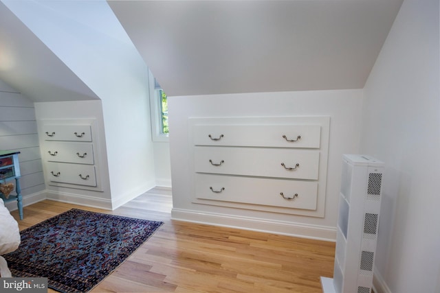 interior space with vaulted ceiling and light hardwood / wood-style flooring