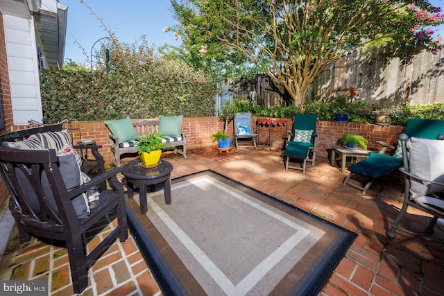 wooden terrace featuring an outdoor hangout area and a patio area